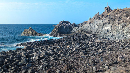 Plaza puerto De Santiago. Canary Islands, Tenerife, Spain. Beach with black volcanic pebble and...