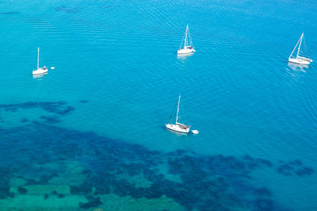 Beautiful view from above of the azure waters of the Ionian Sea and white yachts on the water. Corfu...
