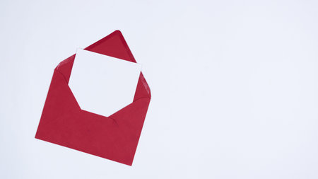 White sheet in a red envelope. Template for text or design. Greeting card for Christmas or another...