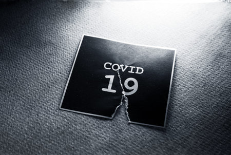 Close up of a COVID-19 text tag on paper