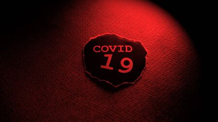 Close up of a COVID-19 text tag on paperの写真素材