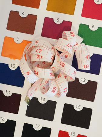 Measuring tape on colorful fabric catalogの写真素材