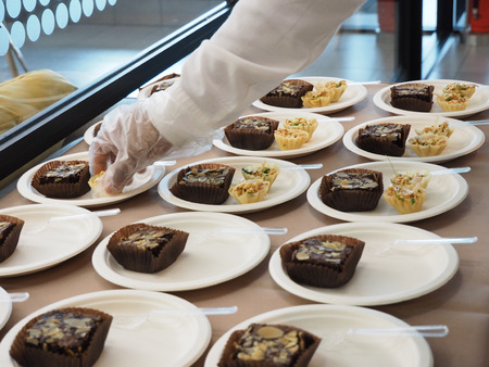 Catering staff preparing snack set for coffee brake.の写真素材