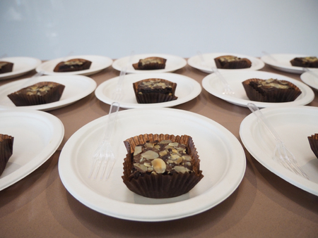 Chocolate crownie on white plastic plate for coffee brake.の写真素材