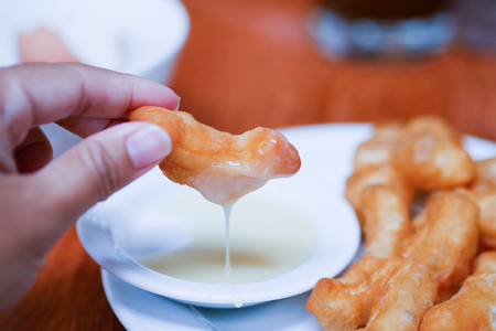 Chinese doughnut dipping sweetened condensed milk.の写真素材