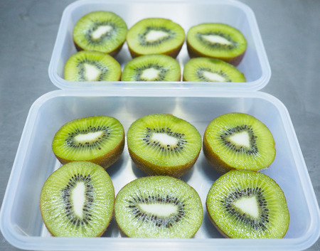 Green kiwi sliced in food box.の写真素材