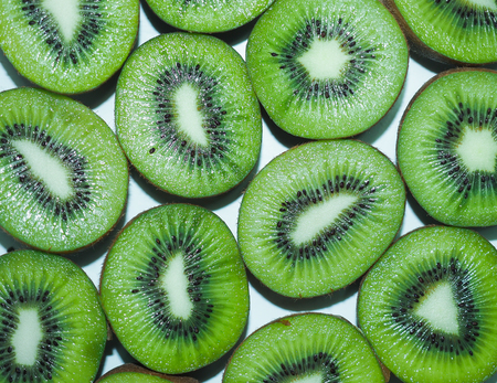Green kiwi sliced backgroundの写真素材