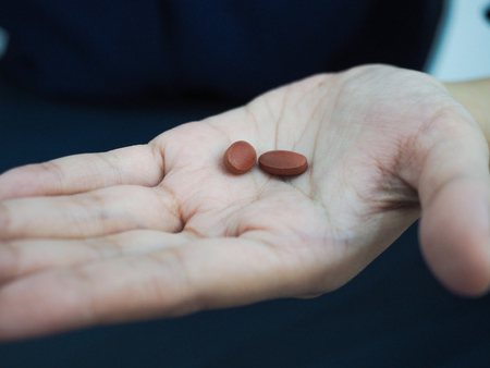 Two pills on hand.の写真素材
