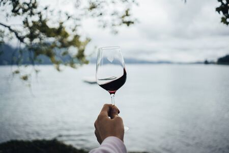 Glass of red wine at Lake Lucerneの写真素材