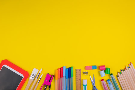 Set of school items on orange background. Back to school concept. Top view. Copy spaceの写真素材