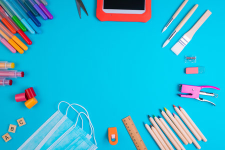 Set of school items on a blue background. Back to school concept. Top view. Copy spaceの写真素材