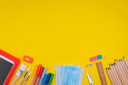 Set of school items on orange background. Back to school concept. Top view. Copy spaceの写真素材