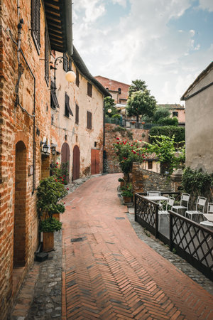Ancient village of Certaldo in Tuscany, Italy during a summer morning, blue sky with clouds, architecture, alleys, Boccaccio, medievalのeditorial素材