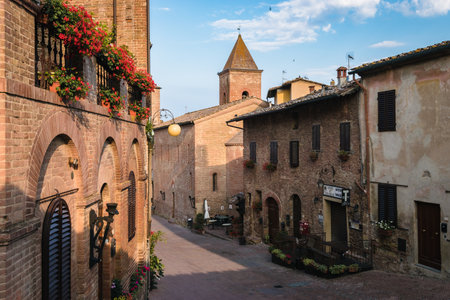 Ancient village of Certaldo in Tuscany, Italy during a summer morning, blue sky with clouds, architecture, alleys, Boccaccio, medievalのeditorial素材