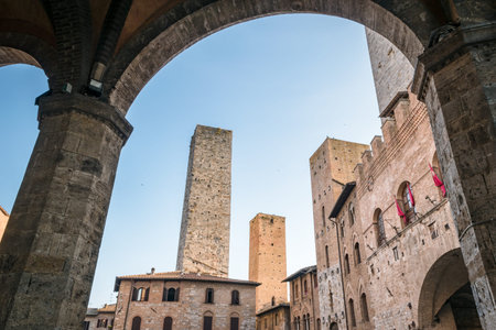 View of the famous towers from the historic center of the village of San Gimignano, a heritage of humanity, on a summer morningのeditorial素材