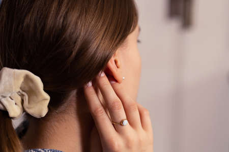 Woman with her blond hair in ponytail with light scrunchie. Close-up. Blurry background.の写真素材