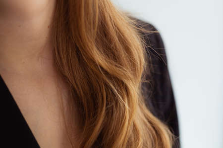 Long blond hair close-up. Business suit. Young woman, bright, white background. Isolatedの写真素材