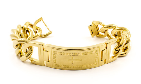 Massive bracelet for men. Stainless steel, gold finish, white backgroundの写真素材