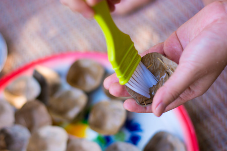Asian women's hand are Prepare packaging for traditional Thai dessert (Khanom Thai)の写真素材