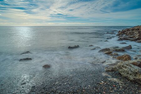 Mediterranean Beach in the "PeÃ±Ã³n del Cuervo" beach in MÃ¡laga. Long exposure.Costa del Sol. Spain.の写真素材