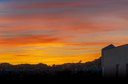 Curious and beautiful orange sunset on city.