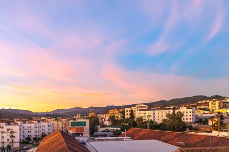 Curious and beautiful yellow sunset on city.の写真素材