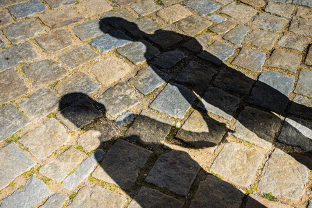 Shadows of a two children boys on streetの写真素材