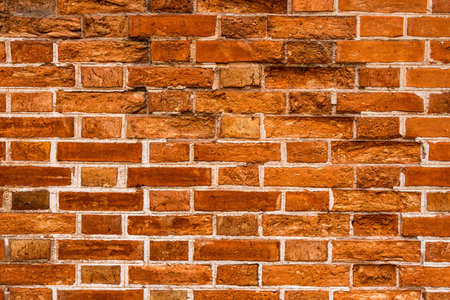 Background of old weathered orange brick wall.