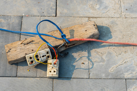 Plug socket and cable connecting on wooden,It's very dangerous.の写真素材