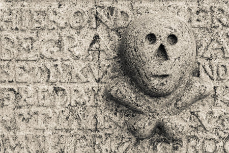 Skull and bones at tombstoneの写真素材