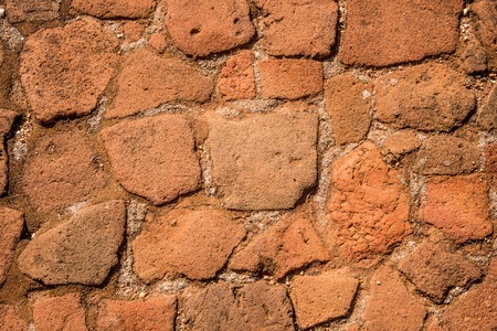 Old cobblestone road with soil between stones. Texture and background.の写真素材