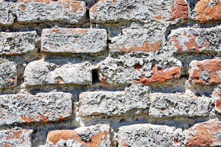 Detail of a decayed and weathered red brick wallの写真素材