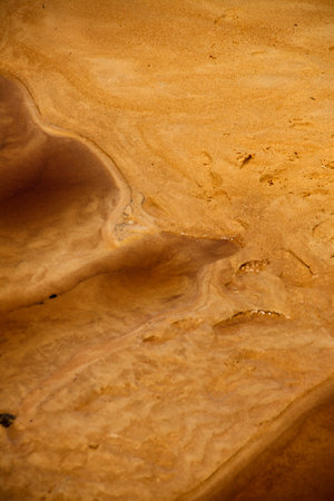 River bed of red sand with a wavy structure on the parched ground
