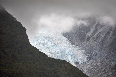 View of the Franz Josef Glacier in cloudy weather with gray clouds.の写真素材