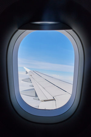 View of the wing of a plane from the porthole.の写真素材