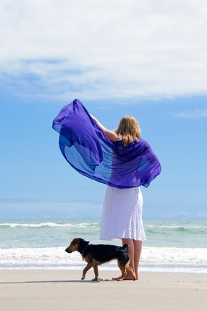 Girl with dog at beachの写真素材