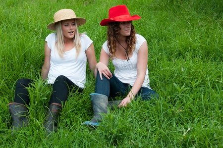 Women sitting in fieldの写真素材