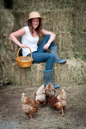 Farm girl with chickensの写真素材