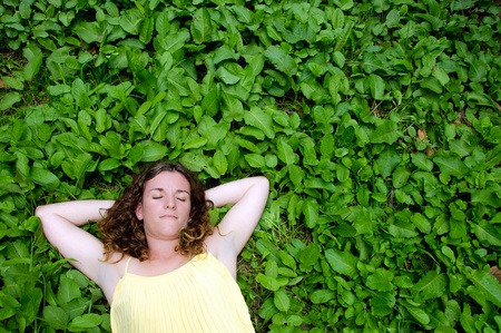 Woman resting in meadow in the sun の写真素材