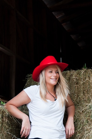 Farm girl in a barn with hayの写真素材