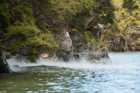 Steam rising from geothermal activity in lakeの写真素材