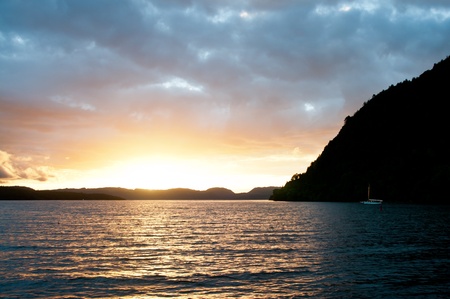 Sunset with yacht harbouring in bayの写真素材