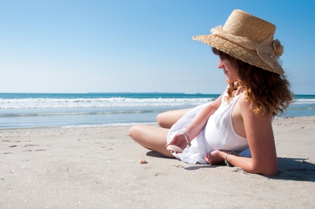 Woamn resting on the beach in summerの写真素材