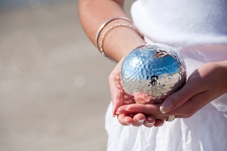 Hands holding a silver ballの写真素材