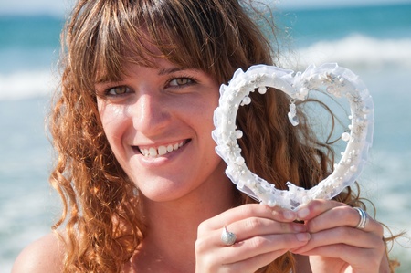 Woman holding a love heart in laceの写真素材