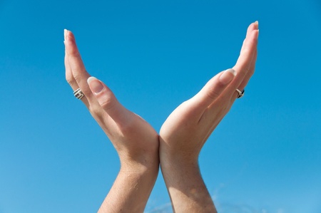 Hands cupped against the skyの写真素材