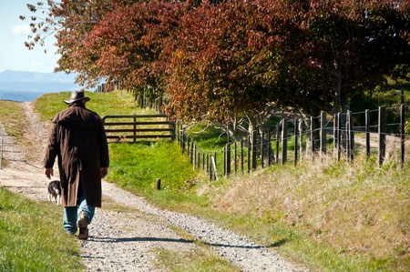 Farmer walking on the farm in autumnの写真素材