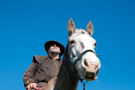 Farmer riding horseの写真素材