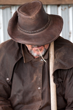 Farmer in barn chewing hayの写真素材