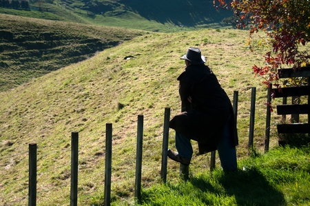 Farmer leaning on fenceの写真素材